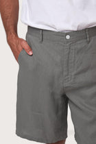 Close-up of the linen fabric texture and refined tailoring details on the grey bermuda shorts