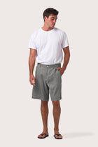 Model wearing the grey linen bermuda shorts by By The Sea Bali