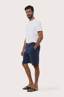 Side profile of the La Brisa linen bermuda shorts showcasing their effortless fit