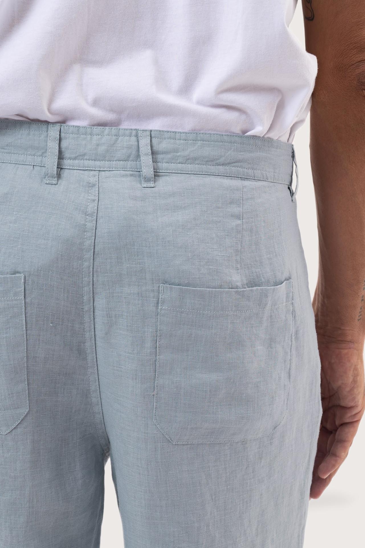 Detailed back view highlighting the relaxed silhouette and linen craftsmanship