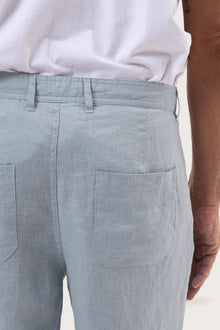 Detailed back view highlighting the relaxed silhouette and linen craftsmanship