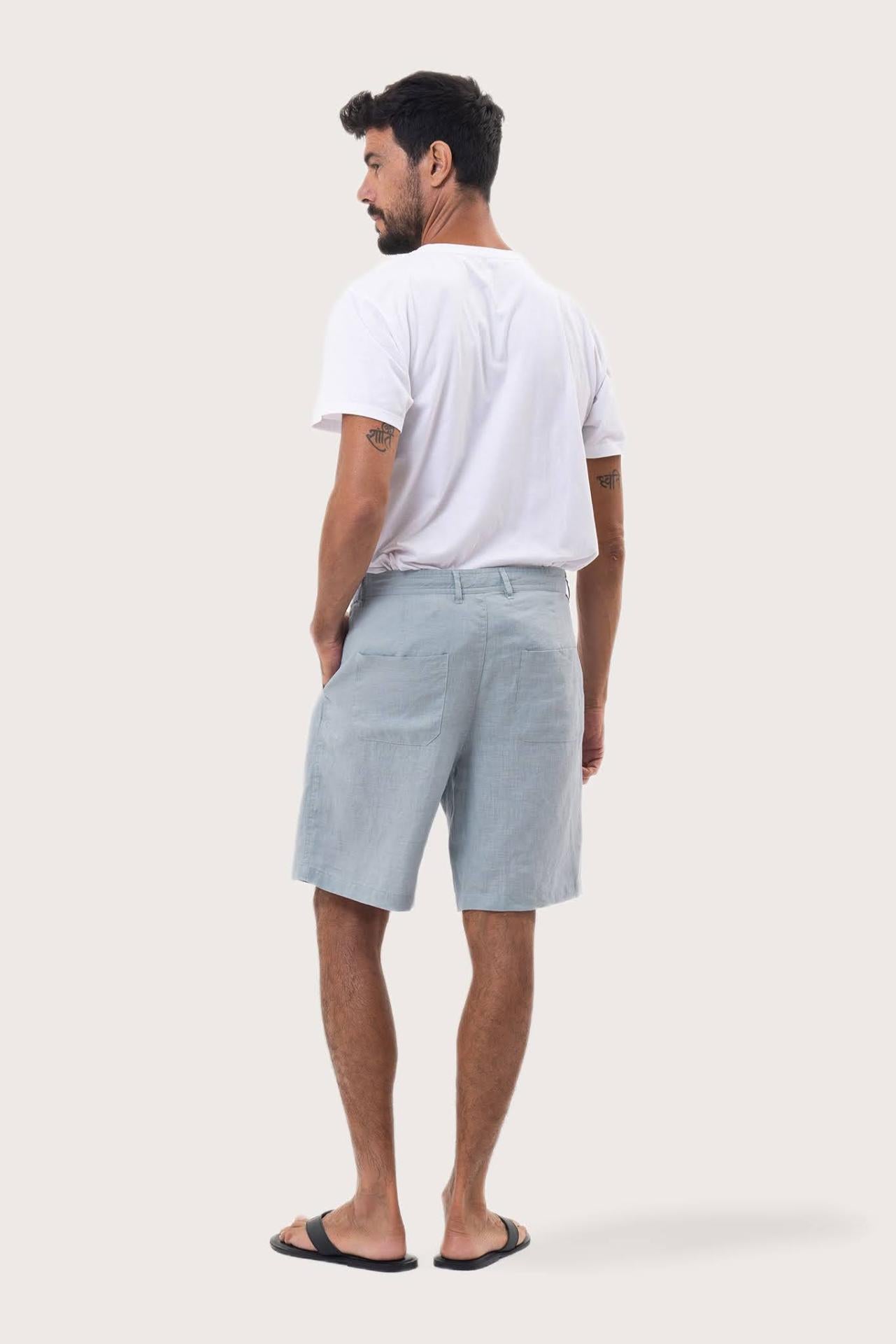 Back view of the light blue linen bermuda shorts with a relaxed and tailored silhouette