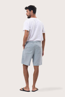 Back view of the light blue linen bermuda shorts with a relaxed and tailored silhouette