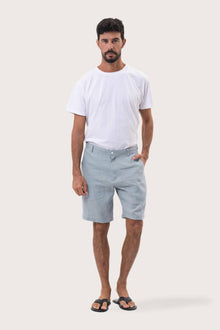 Model wearing the light blue linen bermuda shorts by By The Sea Bali