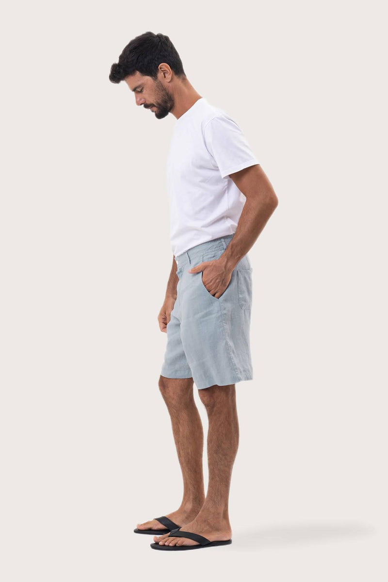 Side profile of the light blue linen bermuda shorts showcasing their effortless fit