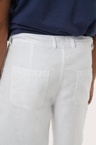 Detailed back view highlighting the relaxed silhouette and linen craftsmanship