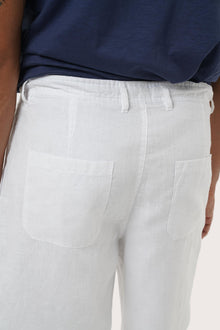 Detailed back view highlighting the relaxed silhouette and linen craftsmanship