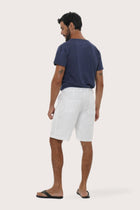 Back view of the white linen bermuda shorts with a relaxed and tailored silhouette