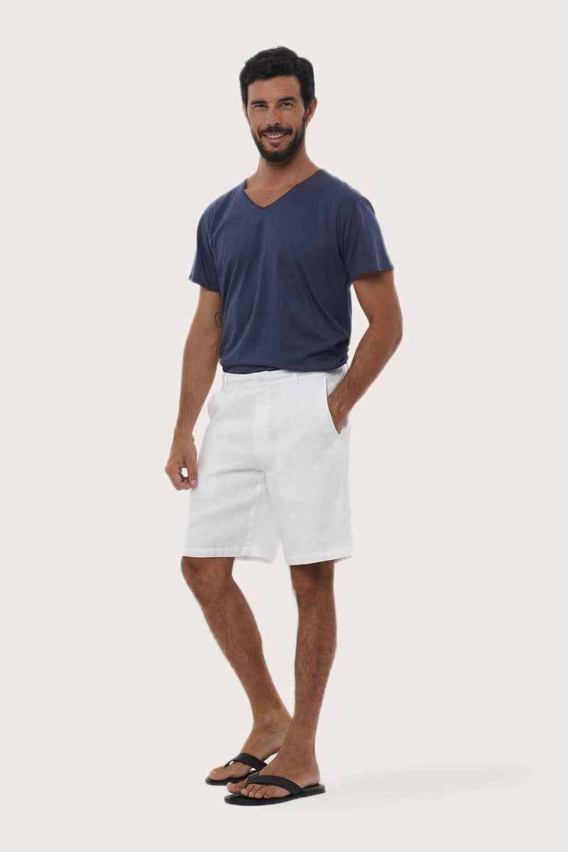 Side profile of the white linen bermuda shorts showcasing their effortless fit