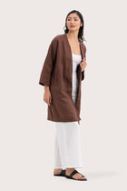 Side profile of the Linen Haori Outerwear Mahogany showing its cut and natural movement