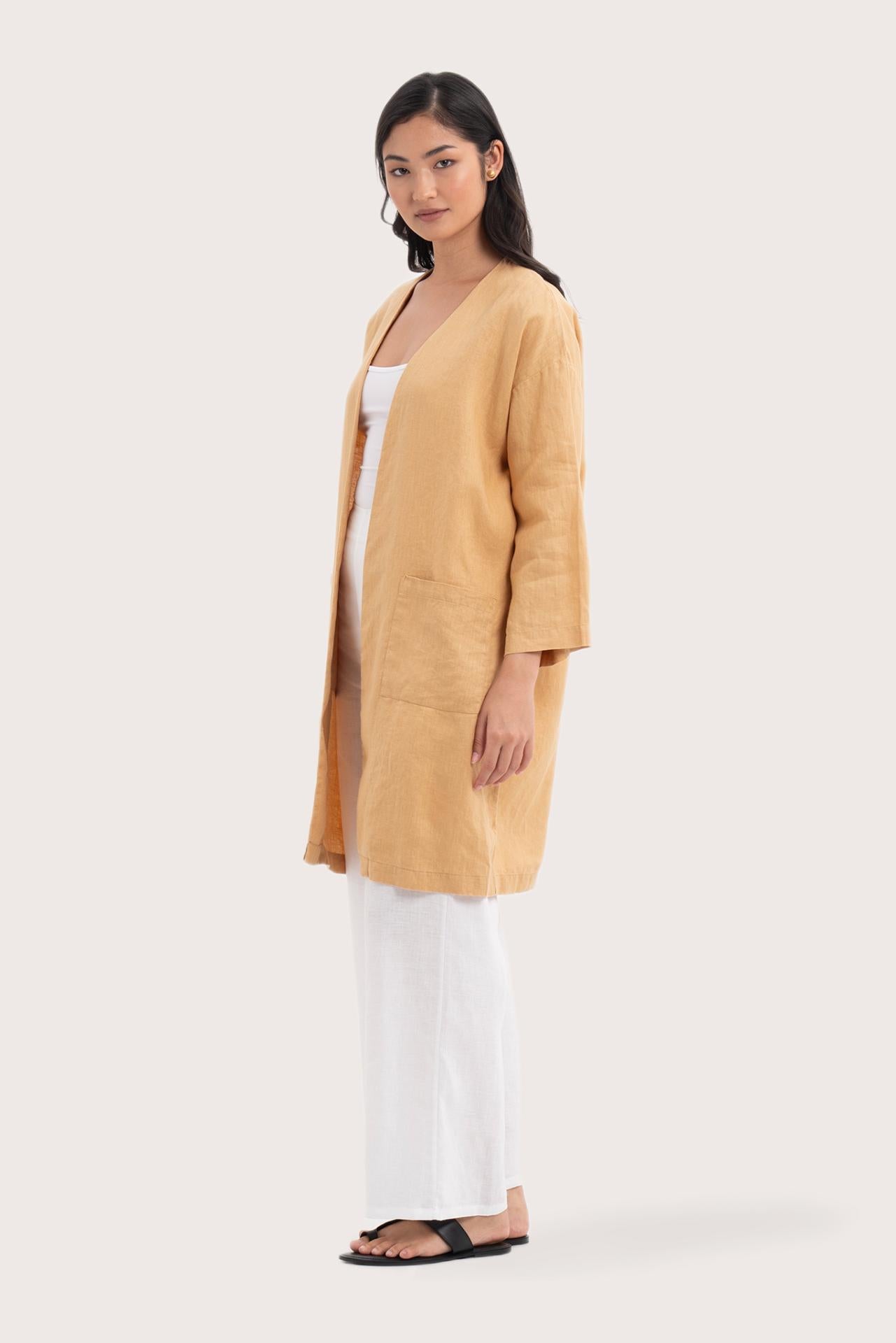 Side profile of the Linen Haori Outerwear Pale Apricot showing its cut and natural movement