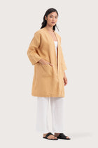 Side profile of the Linen Haori Outerwear Pale Apricot showing its cut and natural movement