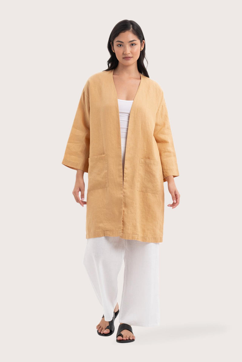 Woman wearing the Linen Haori Outerwear Pale Apricot designed for effortless resortwear and tropical living by By The Sea Bali
