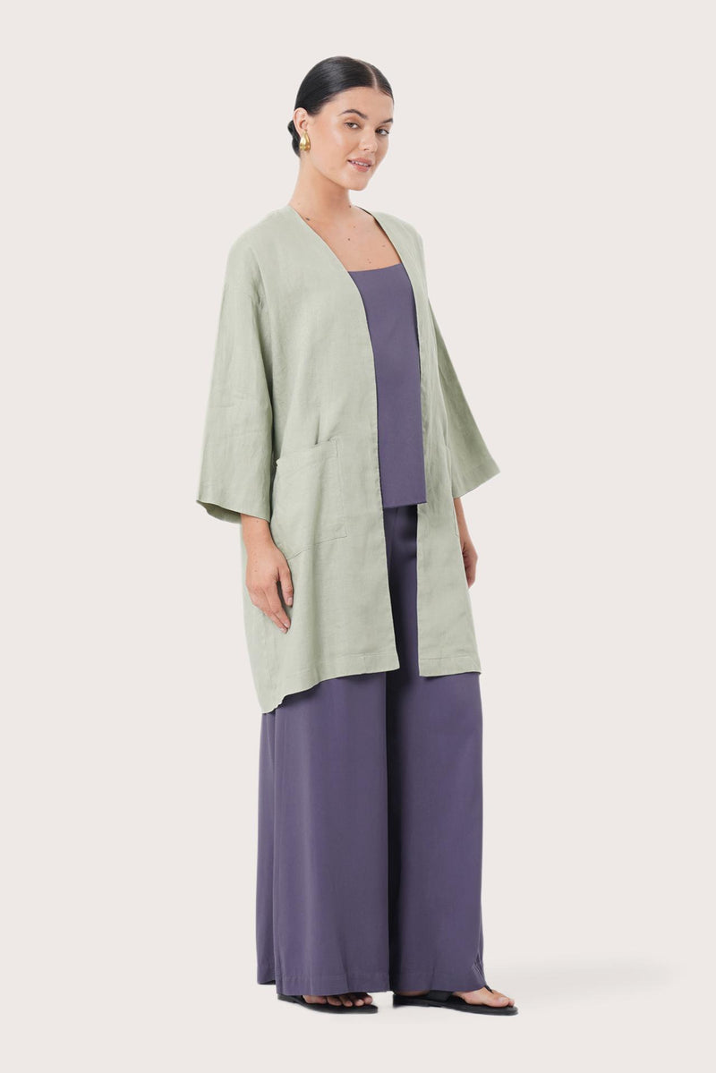 Side profile of the Linen Haori Outerwear Sage showing its cut and natural movement.
