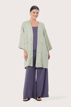 Woman wearing the Linen Haori Outerwear Sage designed for effortless resortwear and tropical living by By The Sea Bali