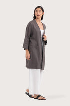 Side profile of the Linen Haori Outerwear Stone showing its cut and natural movement