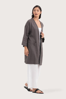Side profile of the Linen Haori Outerwear Stone showing its cut and natural movement