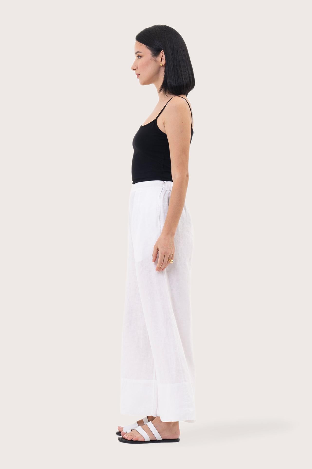 Side profile of the Linen Maxi Length Wide Pants White showing its cut and natural movement.