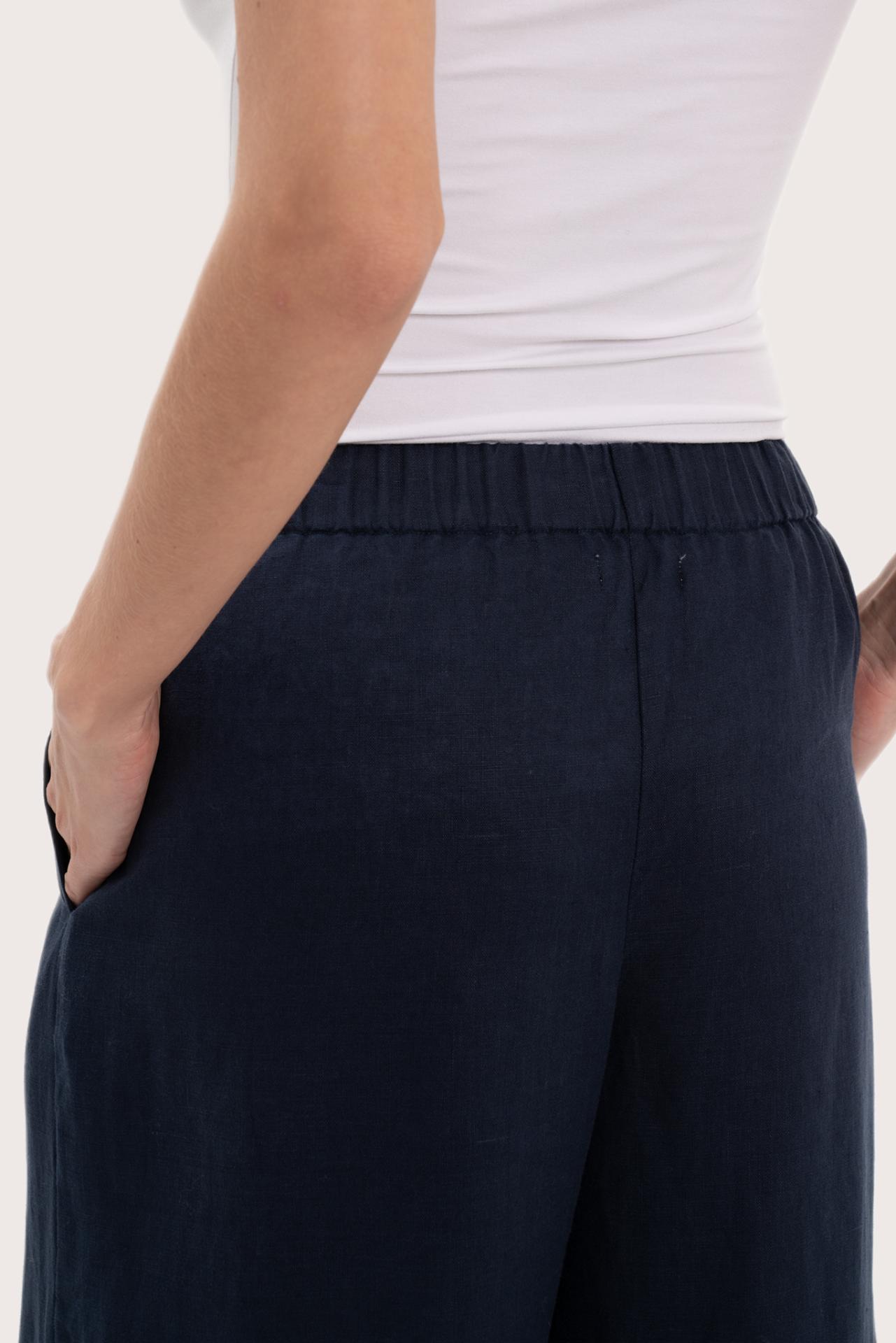 Detailed back view highlighting the wide-leg silhouette and linen craftsmanship