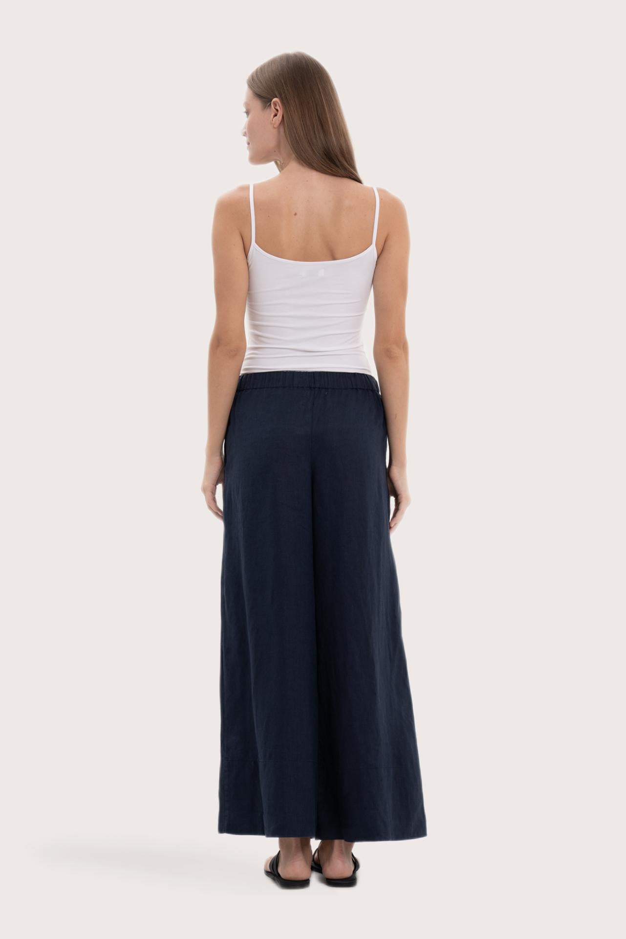 Back view of the navy linen wide-leg pants with a relaxed flowing silhouette