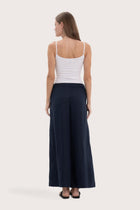 Back view of the navy linen wide-leg pants with a relaxed flowing silhouette