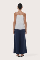 Back view highlighting the lightweight linen fabric, relaxed drape and minimalist design