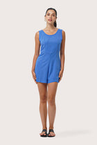 Woman wearing the Lisa Playsuit Blue designed for effortless resortwear and tropical living by By The Sea Bali.