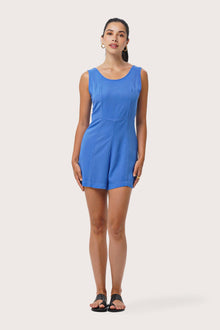 Woman wearing the Lisa Playsuit Blue designed for effortless resortwear and tropical living by By The Sea Bali.