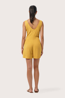 Back view of the Lisa Playsuit Mustard highlighting the garment shape and drape