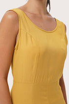 Close up detail of the Lisa Playsuit Mustard highlighting craftsmanship and design features