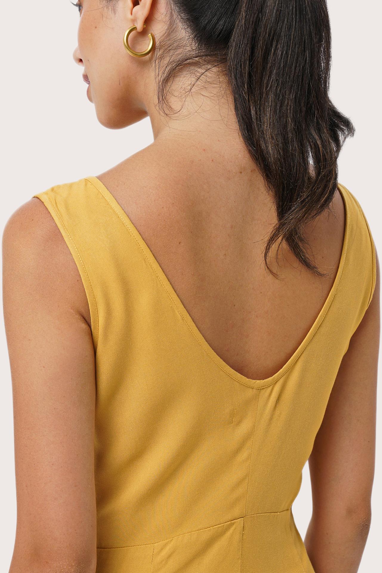Close up detail of the Lisa Playsuit Mustard highlighting craftsmanship and design features