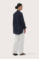 Back view of the Loose Fit Linen Shirt Navy highlighting the garment shape and drape.