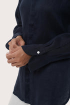 Close up detail of the Loose Fit Linen Shirt Navy highlighting craftsmanship and design features.
