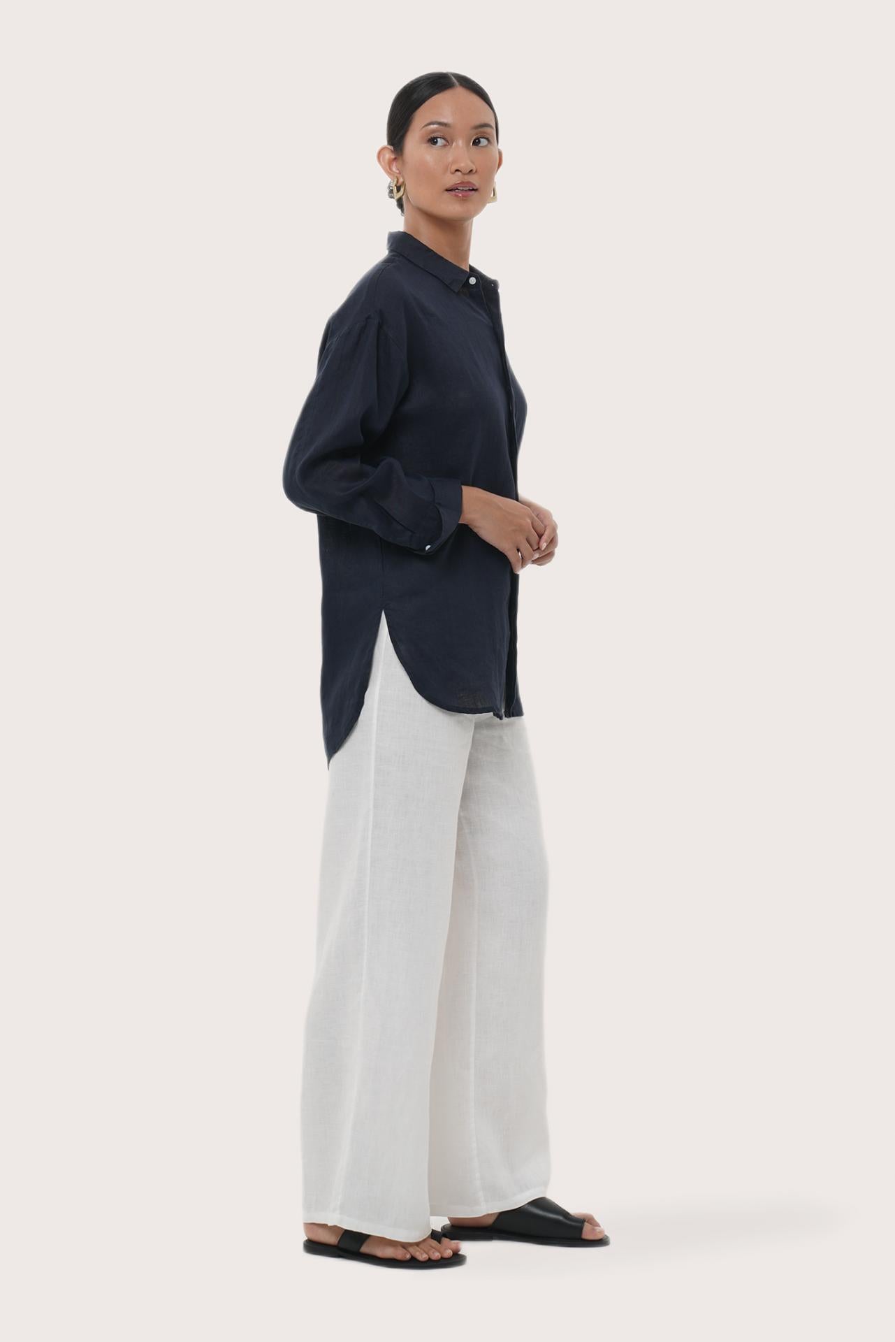 Side profile of the Loose Fit Linen Shirt Navy showing its cut and natural movement.