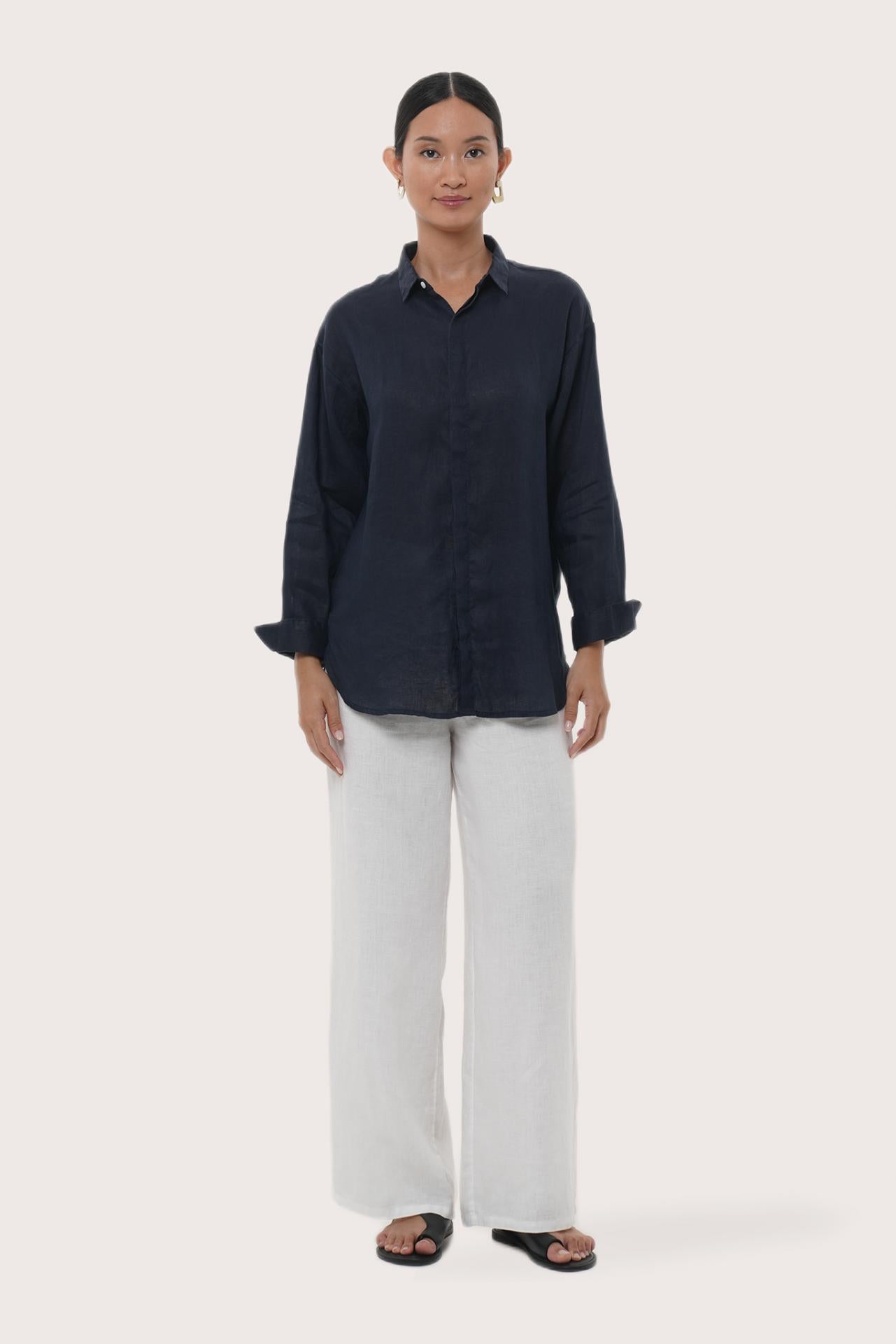 Woman wearing the Loose Fit Linen Shirt Navy designed for effortless resortwear and tropical living by By The Sea Bali.
