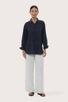 Woman wearing the Loose Fit Linen Shirt Navy designed for effortless resortwear and tropical living by By The Sea Bali.
