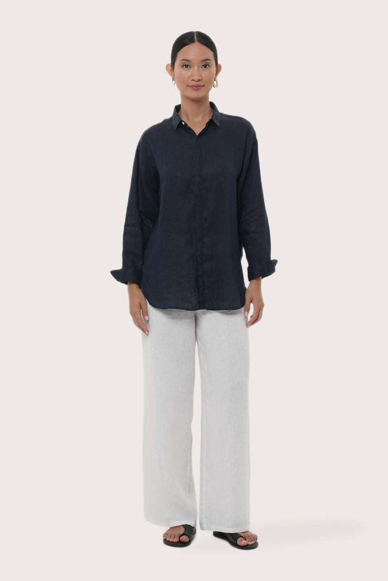 Woman wearing the Loose Fit Linen Shirt Navy designed for effortless resortwear and tropical living by By The Sea Bali.

