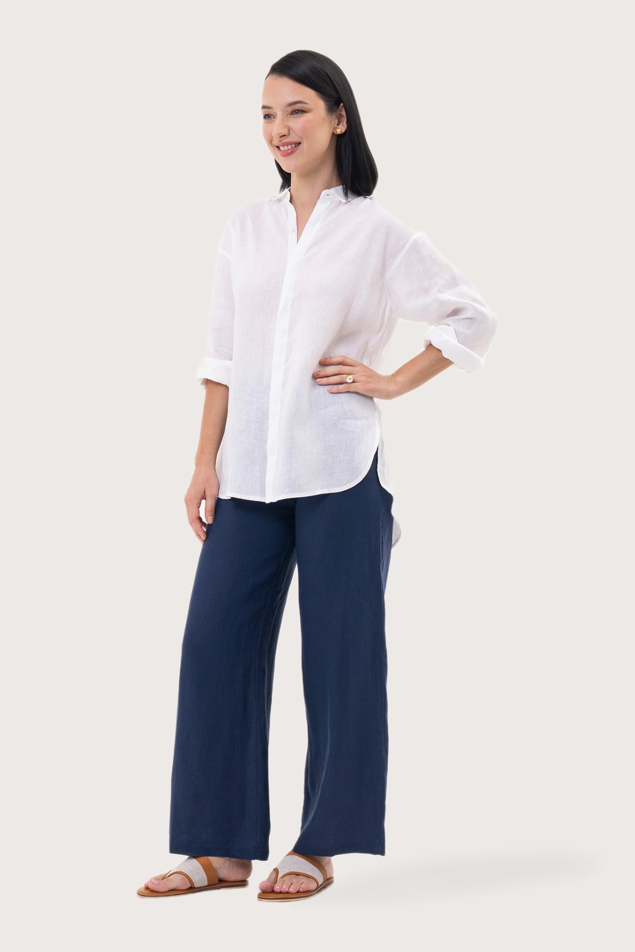 Side profile of the Loose Fit Linen Shirt White showing its cut and natural movement.