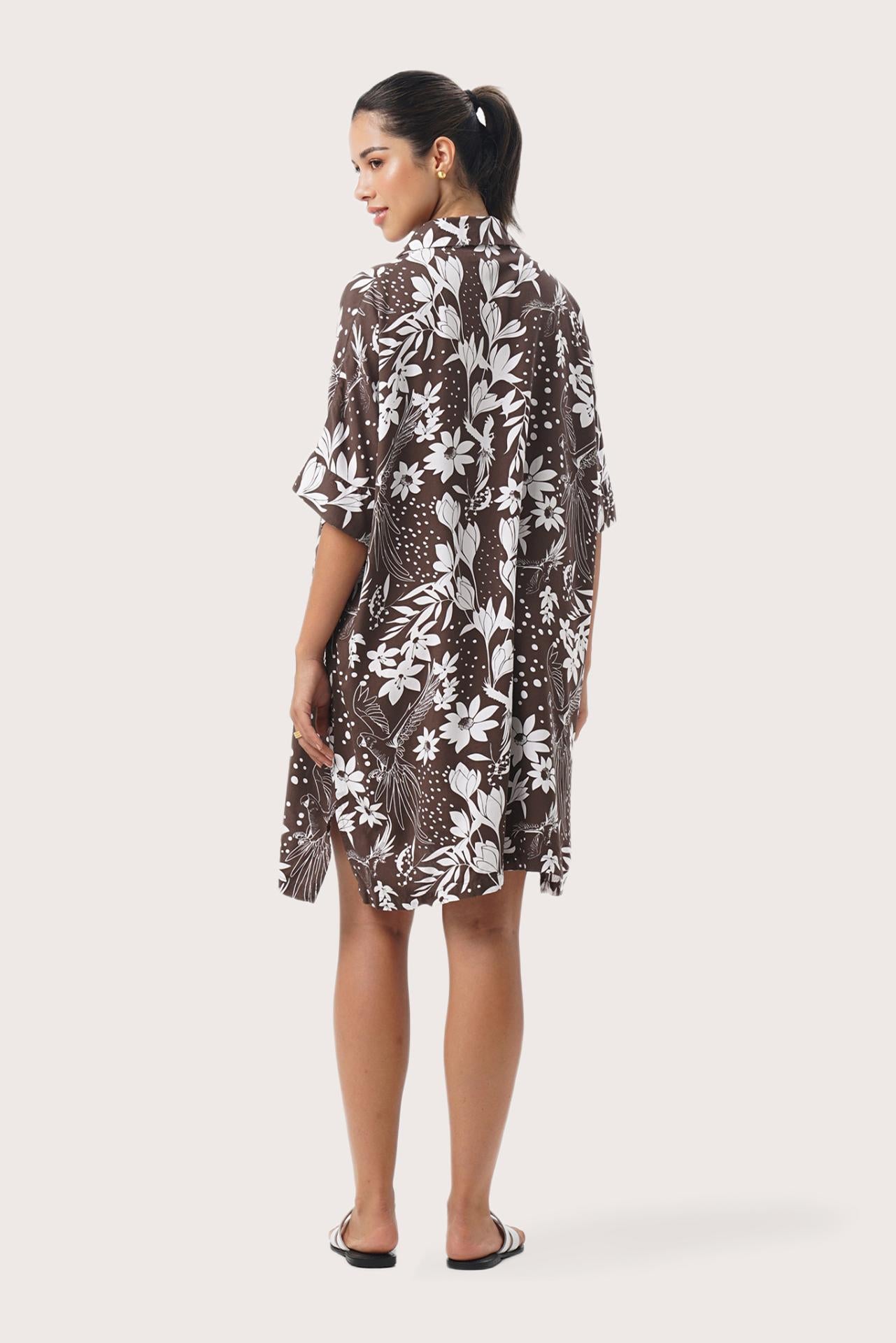 Back view of the Lupita Midi Dress Brown highlighting the garment shape and drape