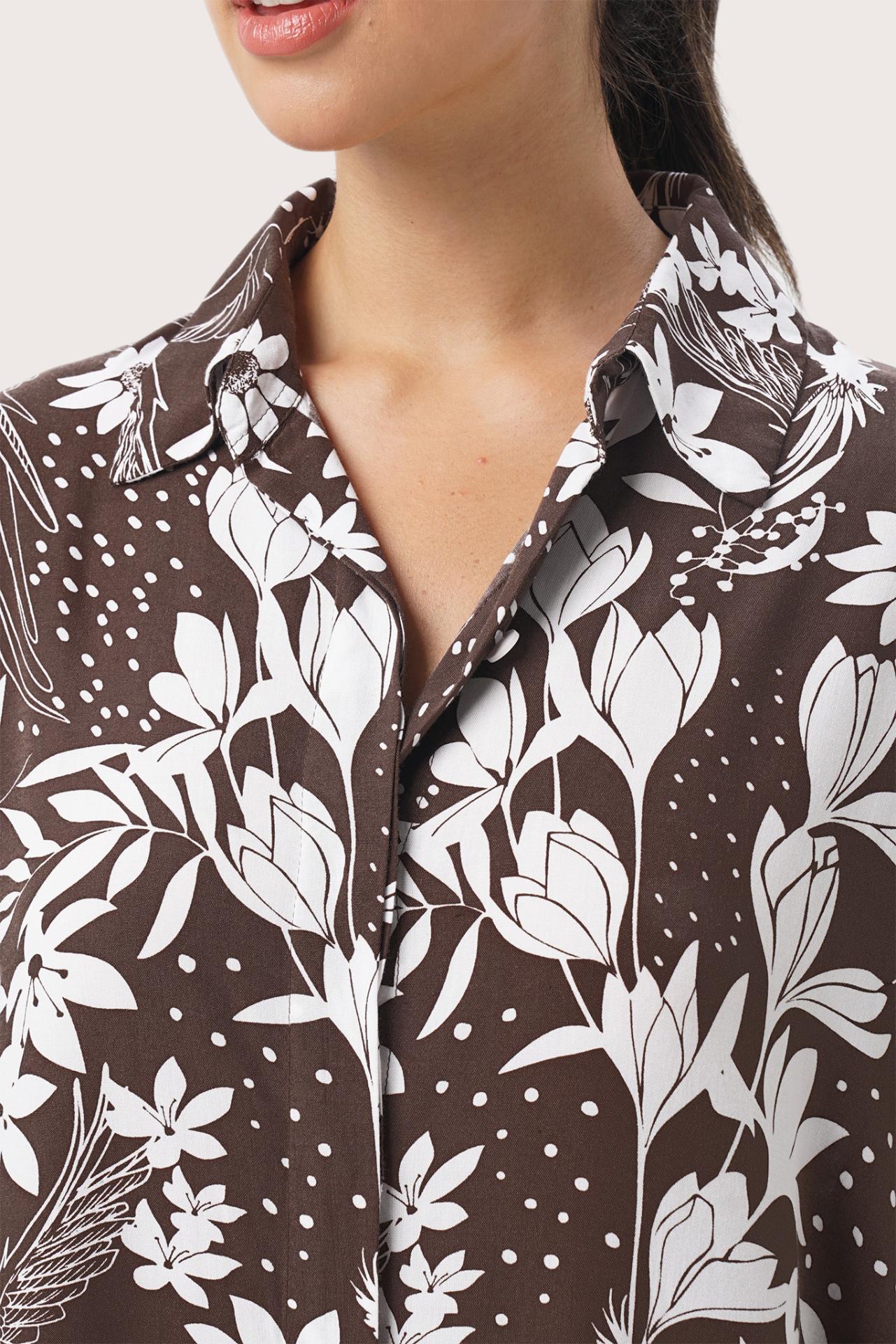 Close up detail of the Lupita Midi Dress Brown highlighting craftsmanship and design features