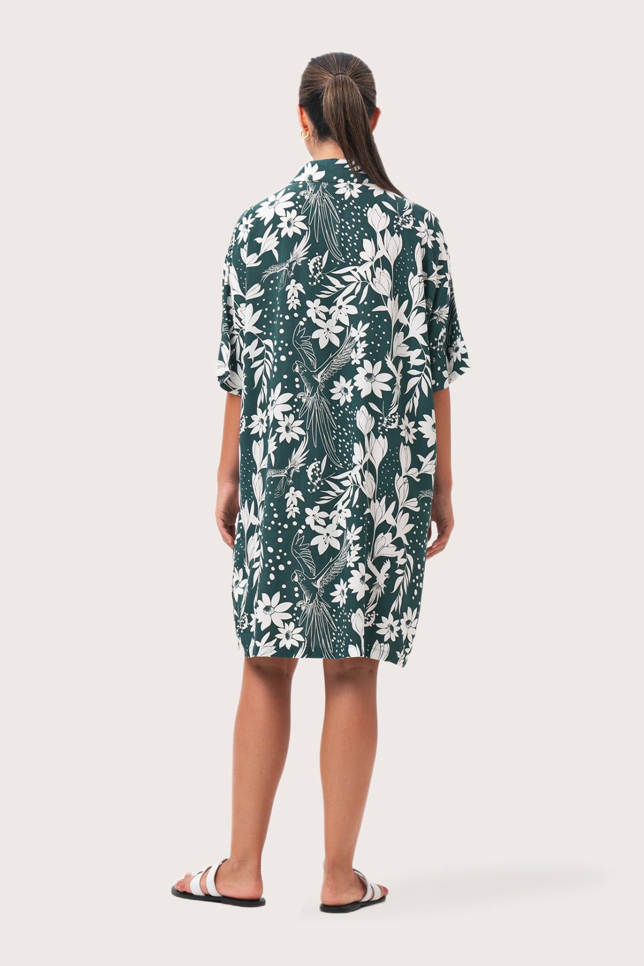 Back view of the Lupita Midi Dress Green highlighting the garment shape and drape