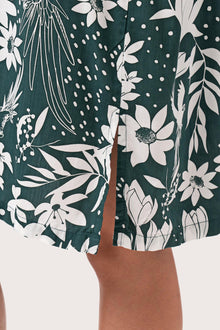 Close up detail of the Lupita Midi Dress Green highlighting craftsmanship and slit design features