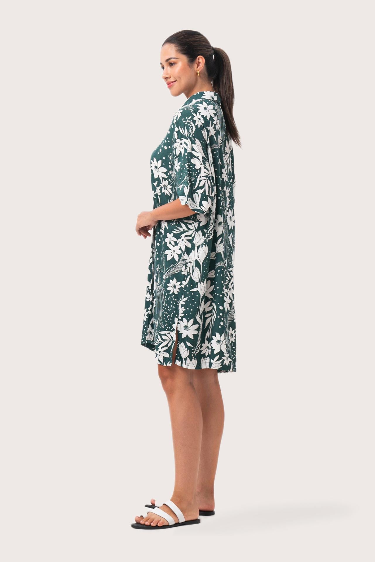 Side profile of the Lupita Midi Dress Green showing its cut and natural movement