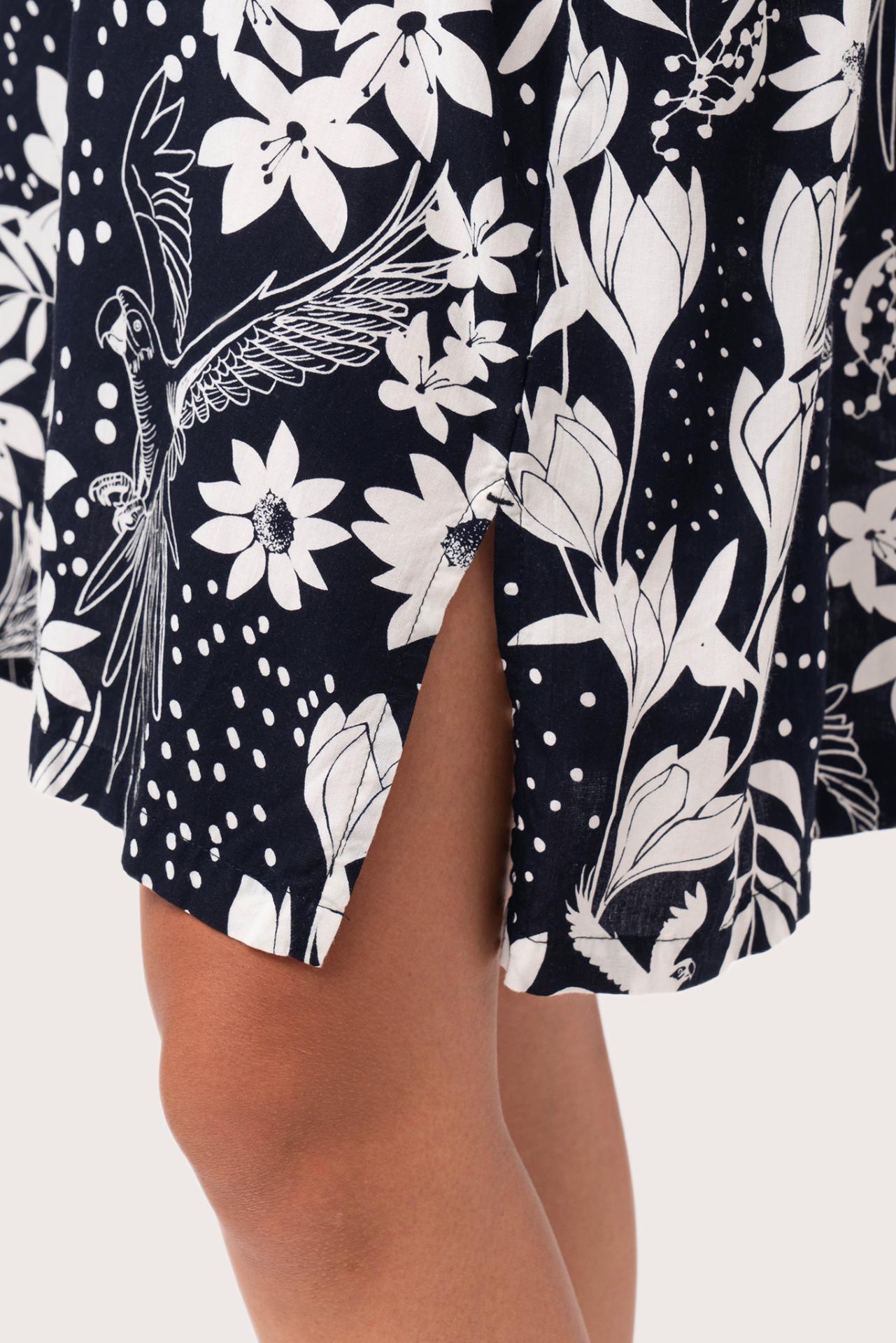 Close up detail of the Lupita Midi Dress Navy highlighting craftsmanship and slit design features