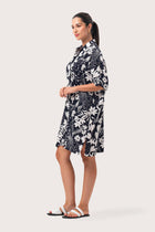 Side profile of the Lupita Midi Dress Navy showing its cut and natural movement