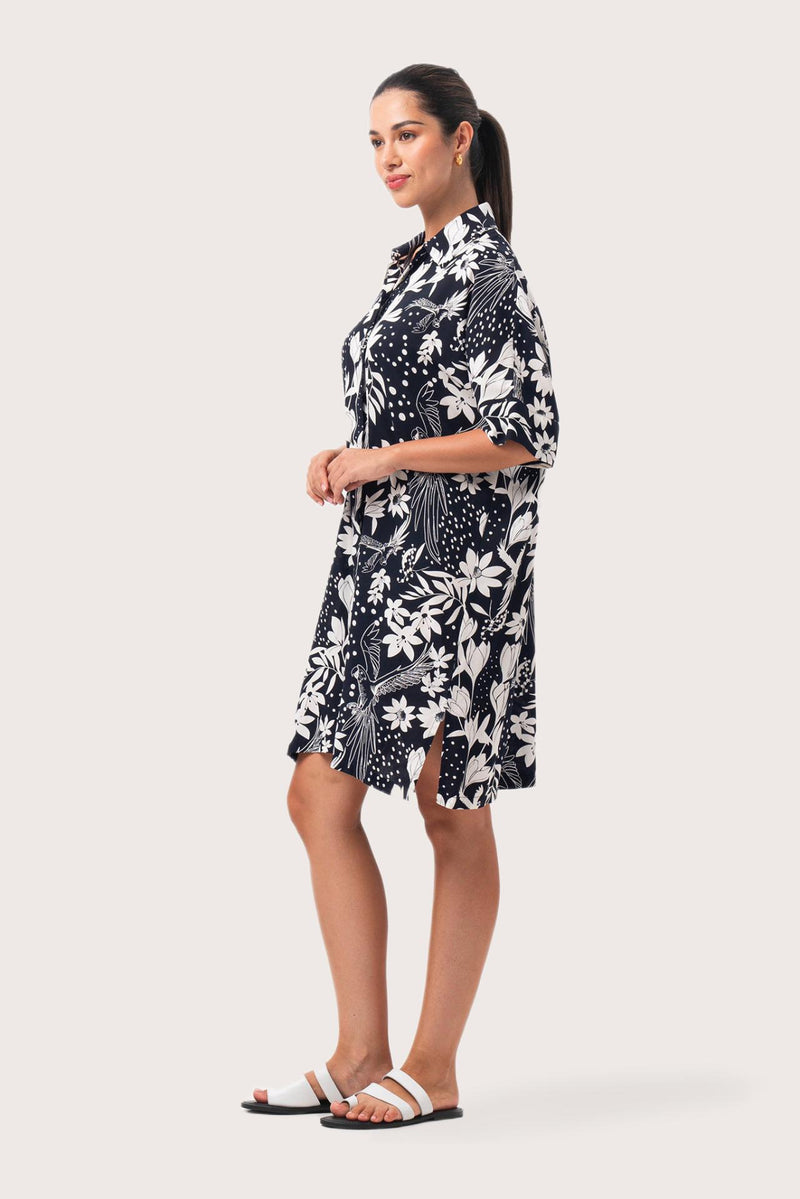 Side profile of the Lupita Midi Dress Navy showing its cut and natural movement