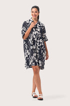 Woman wearing the Lupita Midi Dress Navy designed for effortless resortwear and tropical living by By The Sea Bali