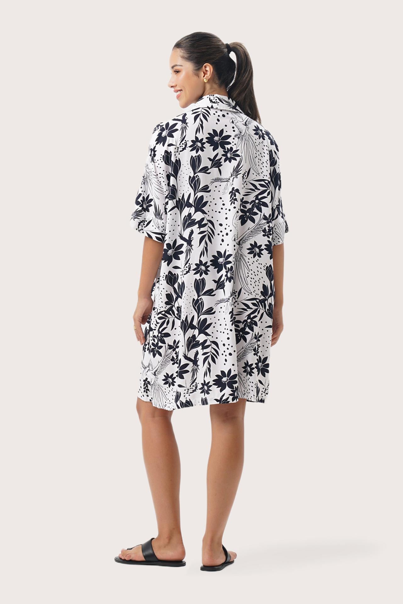 Back view of the Lupita Midi Dress White highlighting the garment shape and drape