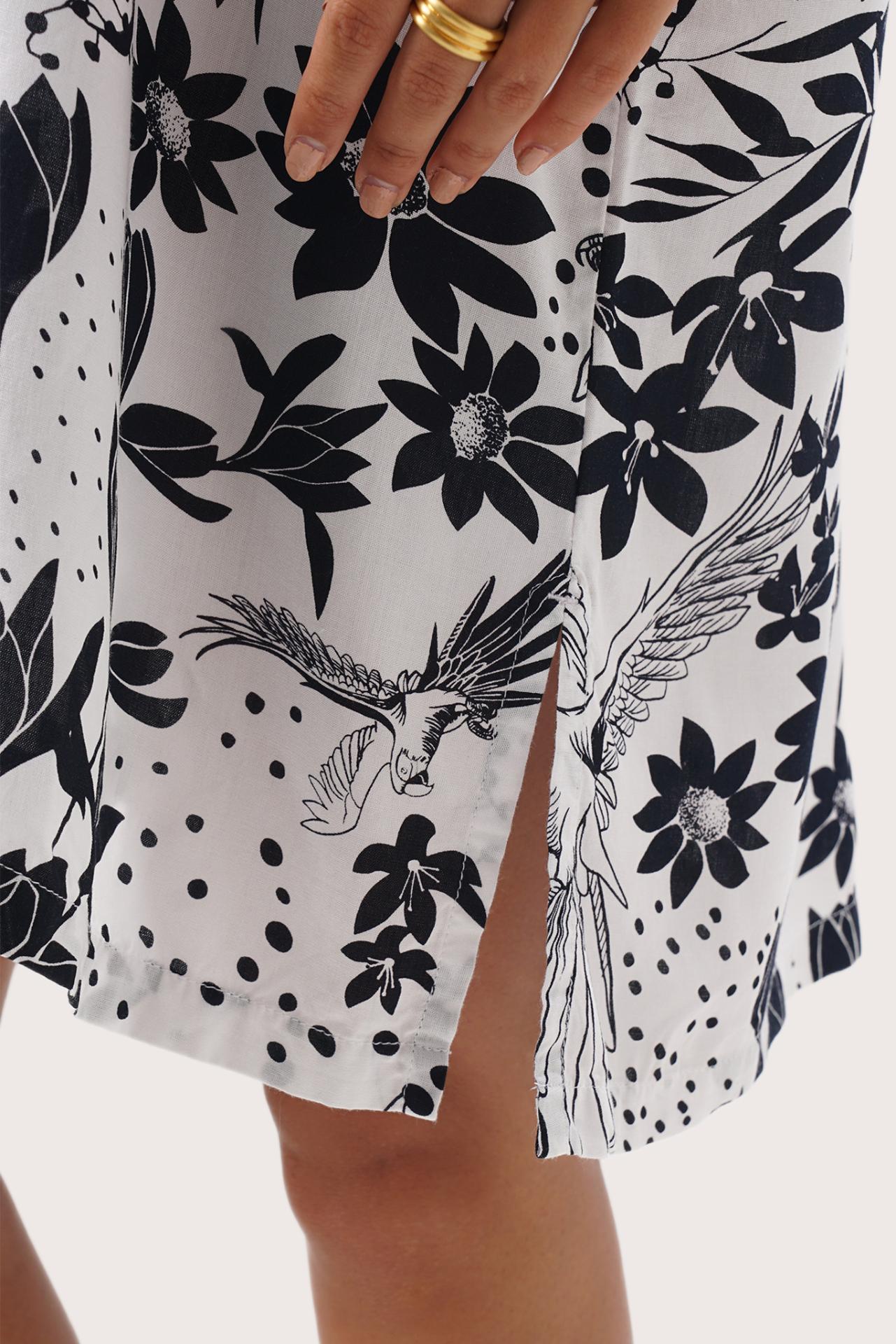 Close up detail of the Lupita Midi Dress White highlighting craftsmanship and slit design features
