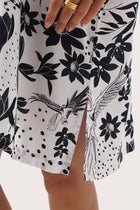 Close up detail of the Lupita Midi Dress White highlighting craftsmanship and slit design features